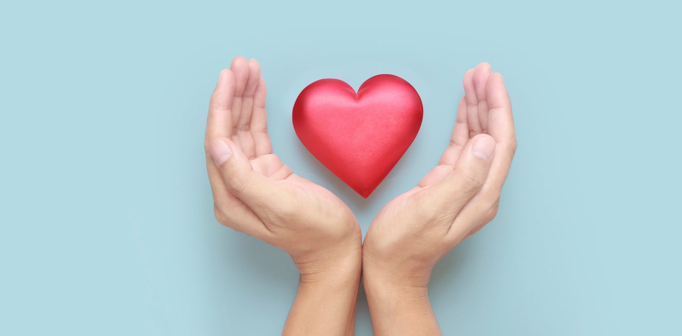 Hands holding  red heart. heart health donation concepts